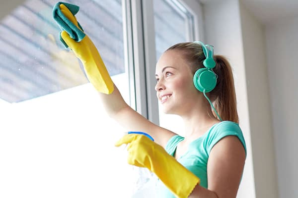 Girl washes a window