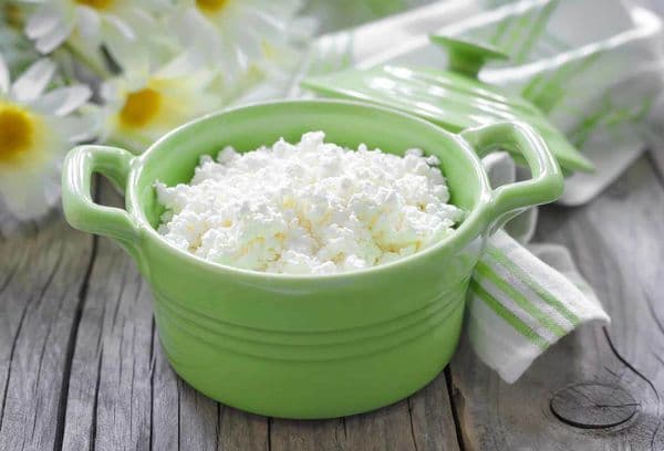 Cottage cheese in a green saucepan