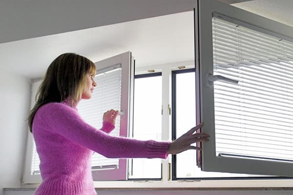 Girl opens a window for airing