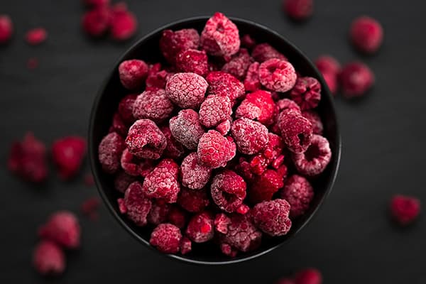 A bowl of frozen raspberries
