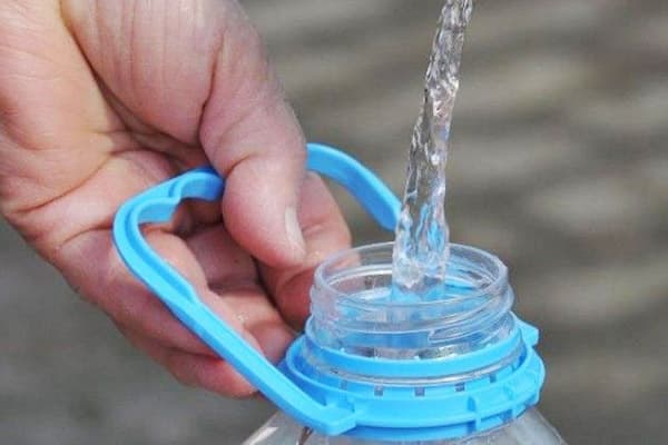 Filling a five-liter bottle with water
