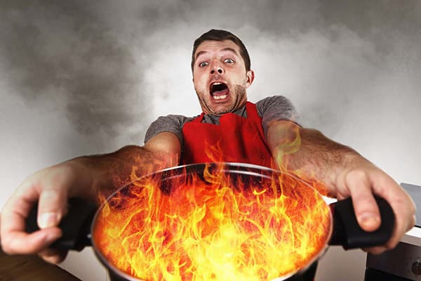 A man with a burning pan