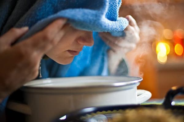 Woman breathing over steam