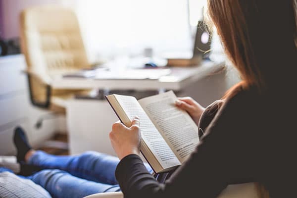 Girl reads a book at home