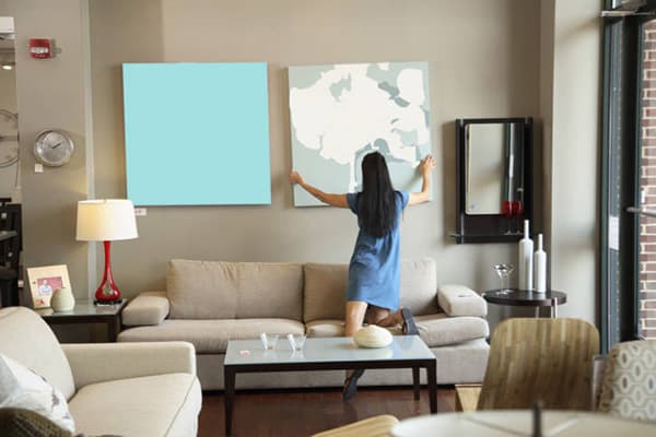 Girl takes a picture from the wall