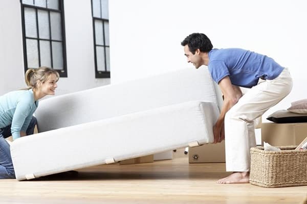 Couple carries a sofa