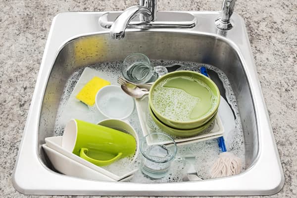 The dishes are soaked in the kitchen sink