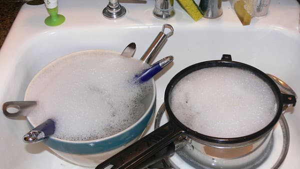 The dishes are soaked in a detergent solution