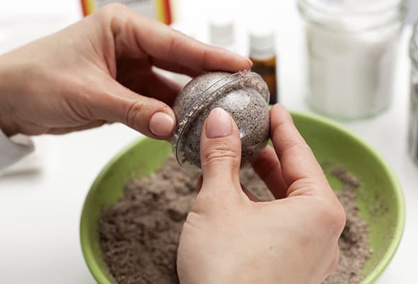Girl sculpts a coffee bomb for a bath