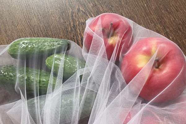 Cucumbers and apples in eco bags