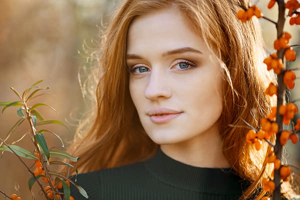 Girl next to a sea buckthorn bush