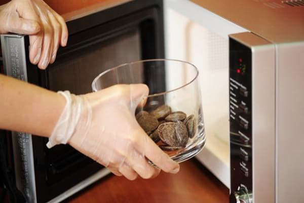 Confectioner puts chocolate in the microwave