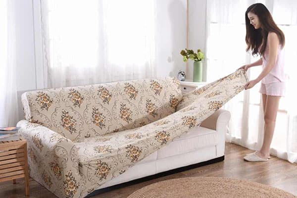 Girl takes cover off the couch