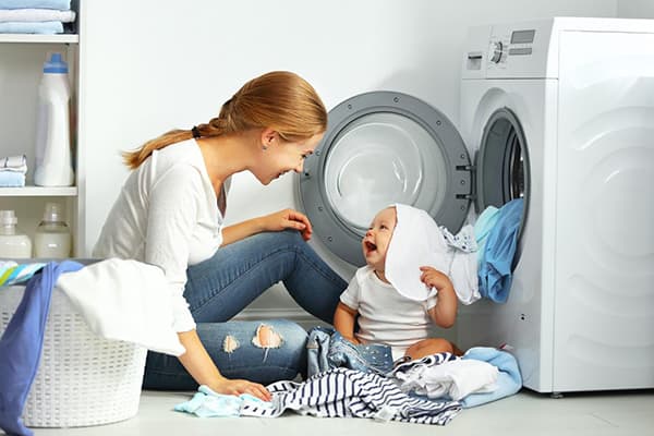 Mom and baby take apart clothes after washing