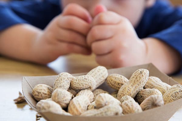 Baby peels peanuts